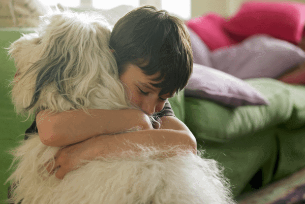 Kid hugging a dog